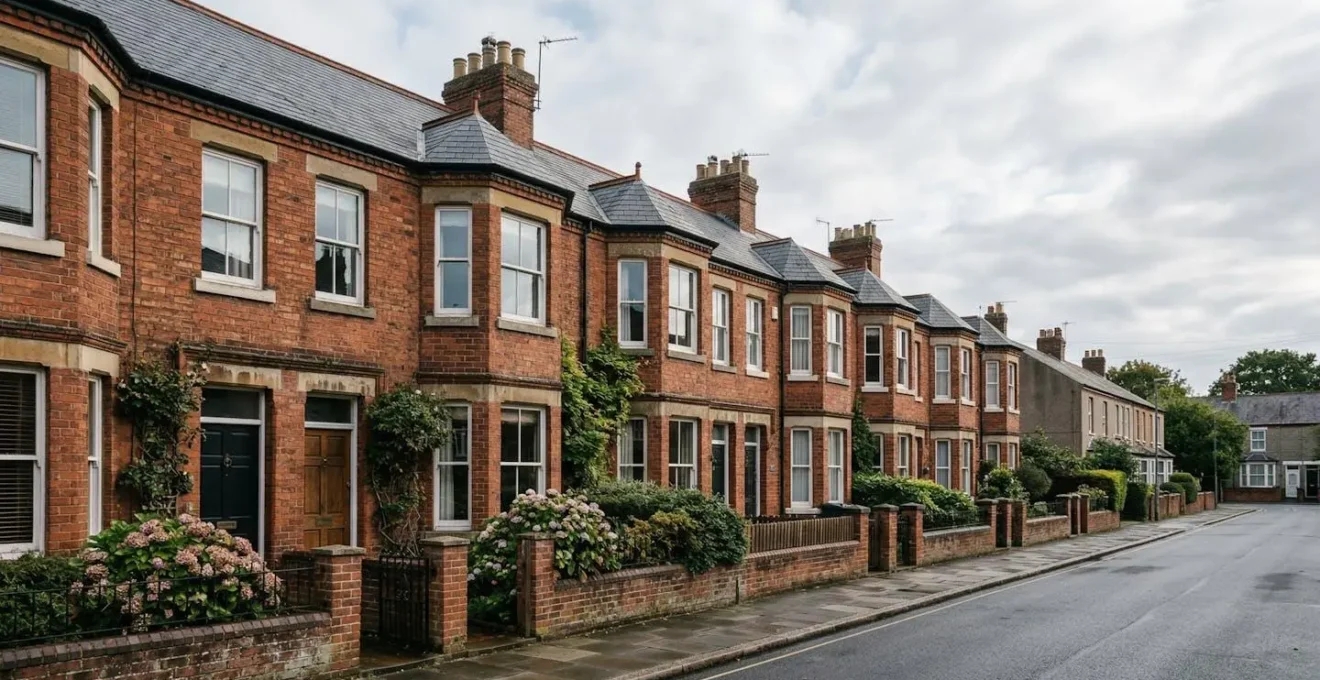 Detailed view of an English Victorian terraced house exterior showing shared boundary wall and traditional red brick architecture