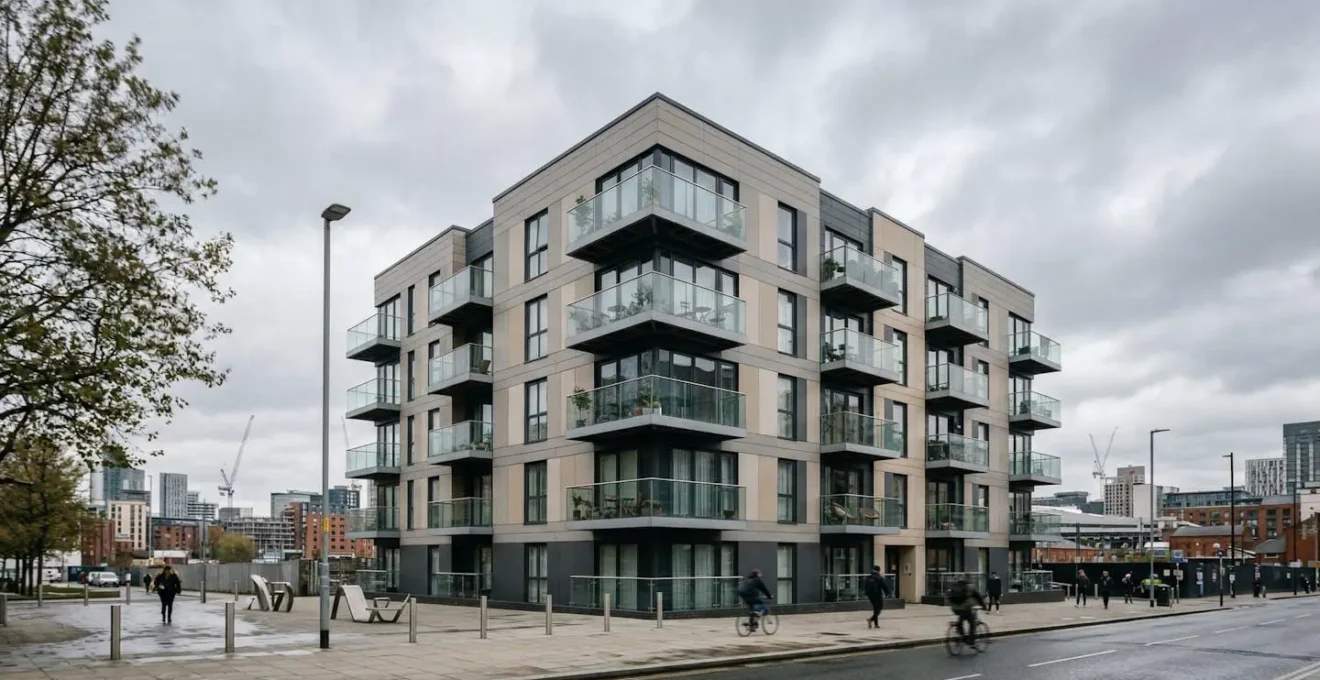 Mid-rise residential apartment block with external cladding system showing building safety concerns in urban England