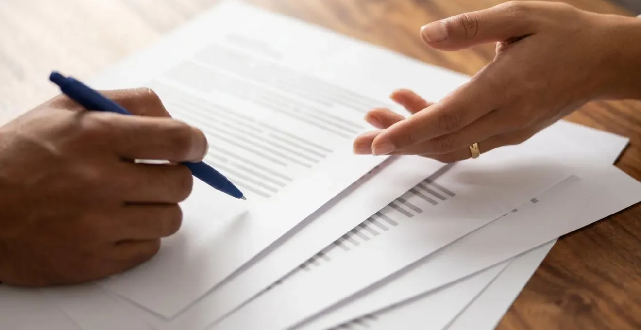 Close-up of professional hands reviewing commercial lease repair clauses with legal documentation