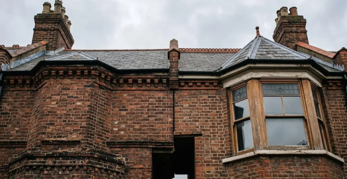 Architectural detail of adjoining terraced houses in England showing the structural interdependence between neighboring properties